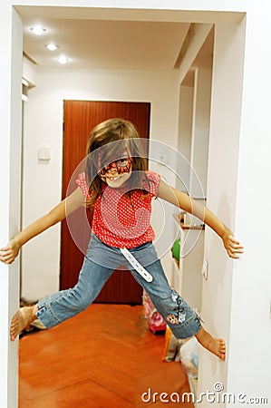 Girl climbing walls in house Stock Photo