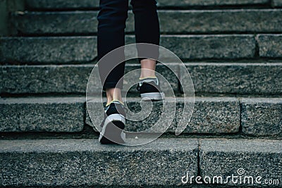 The girl climbs on concrete stairs Stock Photo