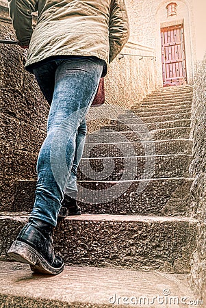 Girl climbs steps of a ladder, atop a bright door. concept of vocation, unknown, destiny Stock Photo