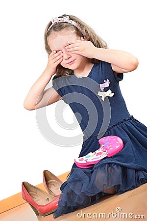 Girl close her eyes while playing with kids make-up Stock Photo
