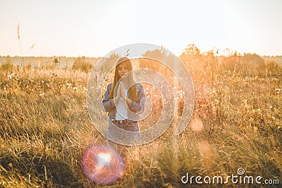 Girl closed her eyes, praying outdoors, Hands folded in prayer concept for faith, spirituality and religion. hope, dreams concept. Stock Photo