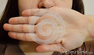 Girl with closed mouth using hand. Prisoner& x27;s Day. Day of Non-Violence Stock Photo