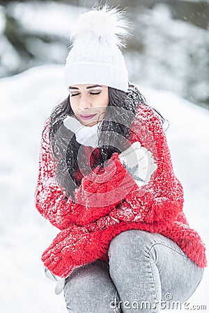 Girl closes her eyes shaking from cold outdoors on a freezing winter day Stock Photo