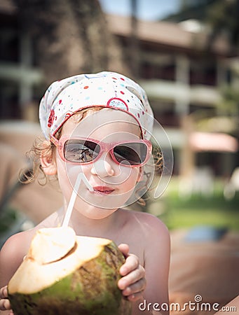 Girl with coconut on beach Stock Photo