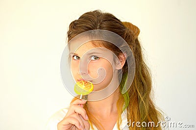 Girl with colored strands and with a lollipop Stock Photo