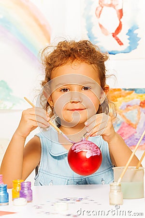 Girl coloring New Year ball for Christmas tree Stock Photo