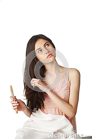 Girl combing hair and looking up Stock Photo