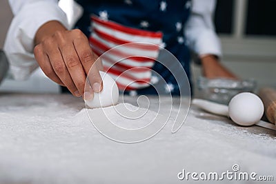 Girl confectioner holding chicken egg in her hand Stock Photo