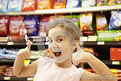 Girl in confectionery supermarket confectionery aisle Stock Photo