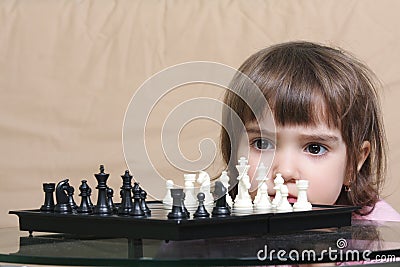 Girl considering chess position Stock Photo