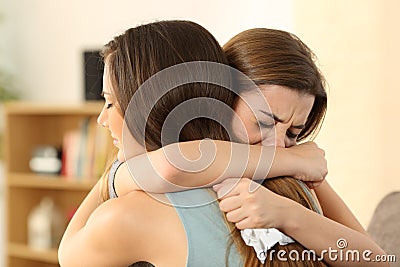 Girl consoling to her sad best friend Stock Photo