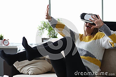 Girl couch emotionally reacts with virtual glasses Stock Photo