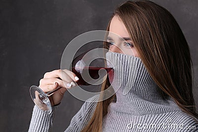 Girl with covered face drinking wine. Close up. Gray background Stock Photo