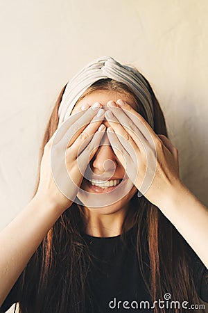 The girl covered her eyes with her hands Stock Photo