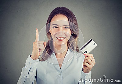 Girl with credit card holding finger up Stock Photo