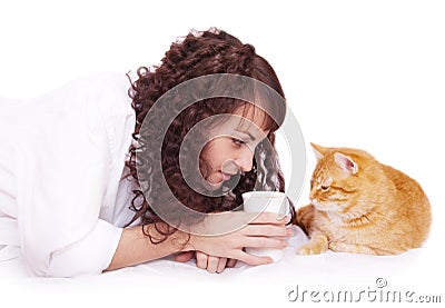 Girl with a cup of coffee and her cat in bed Stock Photo