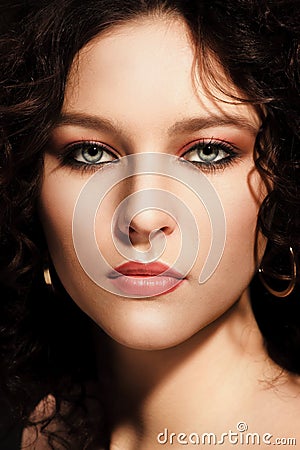 Girl with a curly hairstyle, modern make-up and carnivore look Stock Photo