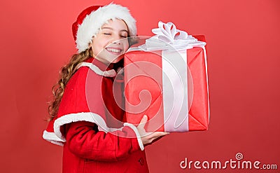 Girl cute child santa costume hold christmas gift box. What is inside. Lets open christmas gift. Happiness and joy Stock Photo