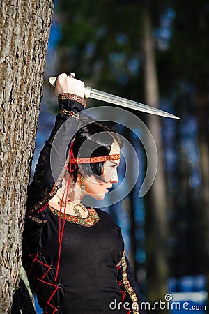 The girl with a dagger Stock Photo