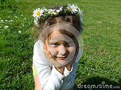 Girl with daisy chain on head Stock Photo