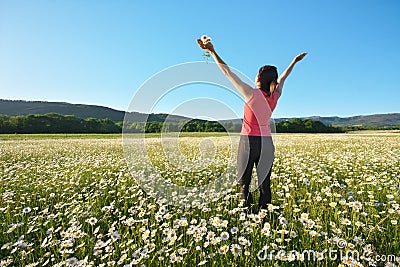 Girl in daisy wheel spring flower field Stock Photo