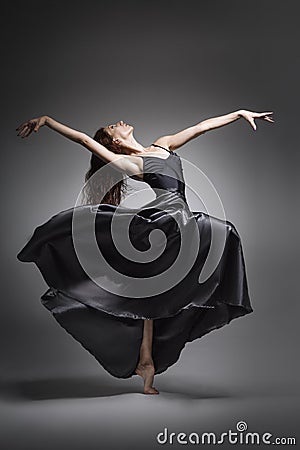 Girl dancer in an elegant, unusual pose. Beautiful girl with long hair Stock Photo