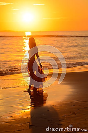 Girl dancing on the beach at sunset,mexico Stock Photo