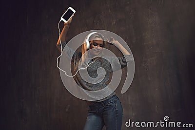 Girl dancing and listening to music in a mobile application. Stock Photo