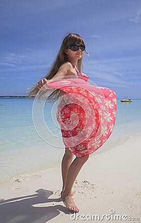 Girl dancing on the white sandy beach Stock Photo