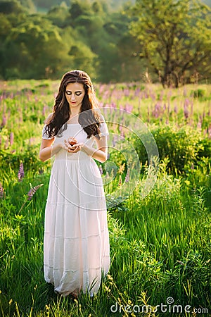 Girl with dark curly hair looking at a nice muffin Stock Photo