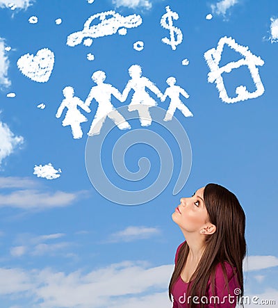Girl daydreaming with family and household clouds on blue sky Stock Photo