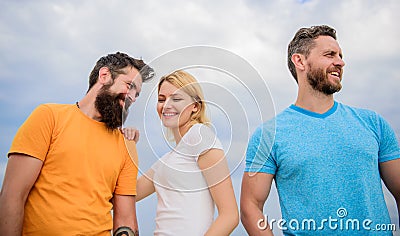 Girl decided with whom dating. Start romantic relationships. Girl stand between two men. Couple and rejected partner Stock Photo