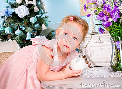 Girl decorate the Christmas tree Stock Photo