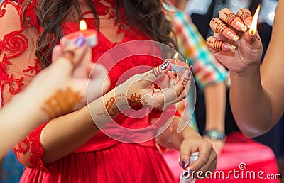 The bride decorated with a decorative candlestick in her hands and a sign . holds a candle in her hand . in the background without Stock Photo