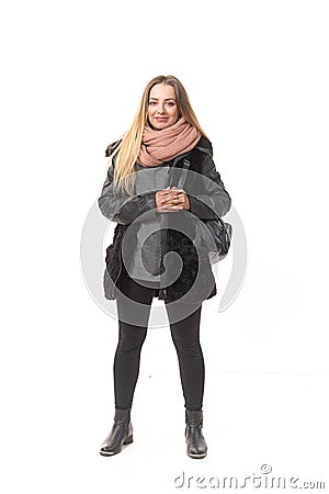 A girl in demi-season clothes with a full-length bag on a white background. Stock Photo