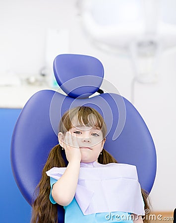 Girl at the dentist complains of toothache. Lookin Stock Photo