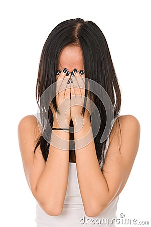 Girl in despair shuts face with hands Stock Photo