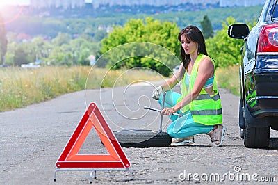 Girl despair with spare wheel replacement. Stock Photo