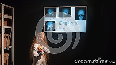 Girl detective uses a negatoscope to complete the quest Stock Photo