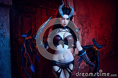 Girl devil in gothic costume and wings and horns Stock Photo