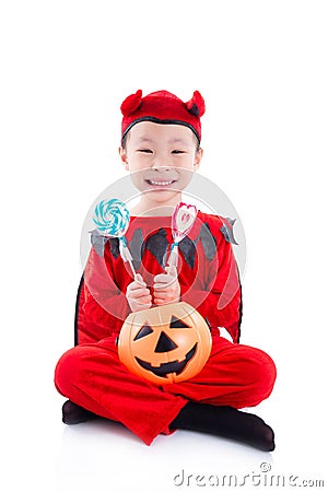 Girl in devil halloween costume sitting over white Stock Photo