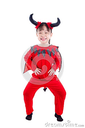 Girl in devil halloween costume standing over white Stock Photo