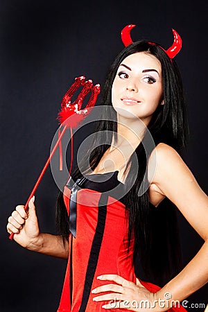 Girl devil holds the magic wand Stock Photo