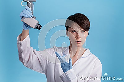 Girl doctor points to the surveillance camera. concept of tracking doctors at work. espionage and invasion of privacy Stock Photo