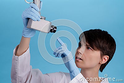 Girl doctor points to surveillance camera. concept tracking doctors at work. espionage and invasion of privacy Stock Photo