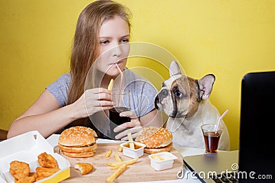 Girl and dog eating fast food Stock Photo