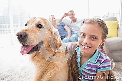 Girl with dog while parents relaxing at home Stock Photo