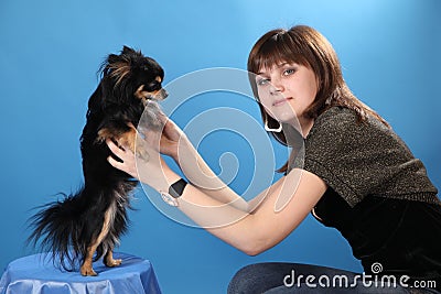 The girl with the doggie on a blue background Stock Photo