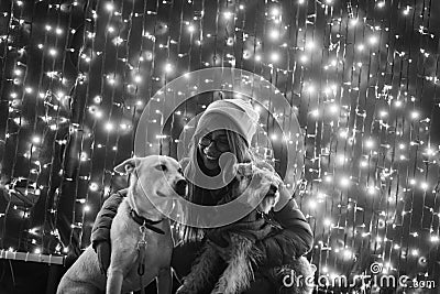 Girl with dogs in black and white and lights in the back Stock Photo