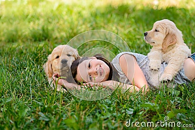 Girl and dogs on grass Stock Photo